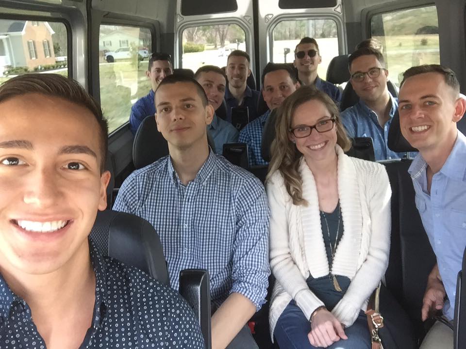 A group of people sitting on the back of a bus.